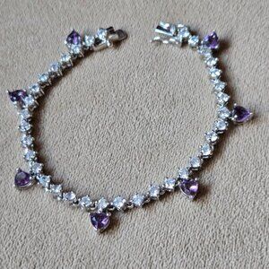 Beautiful sparkly bracelet with dangling purple hearts